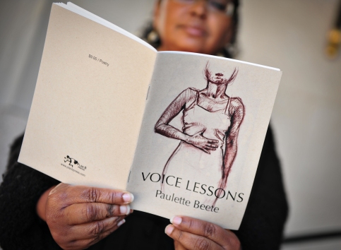 Portrait holding Voice Lessons chapbook